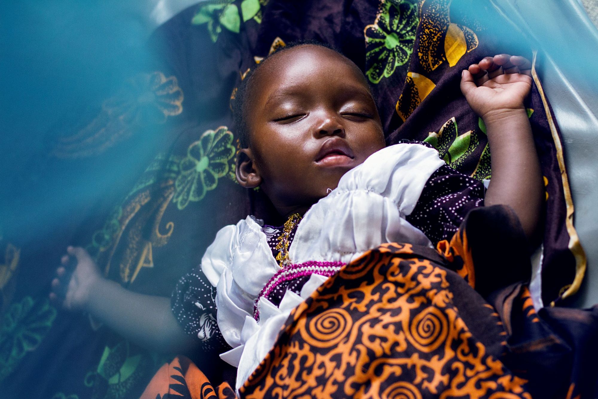 Infant sleeping under a bed net in Tanzania (Photo: Matthis Kleeb/Swiss TPH)