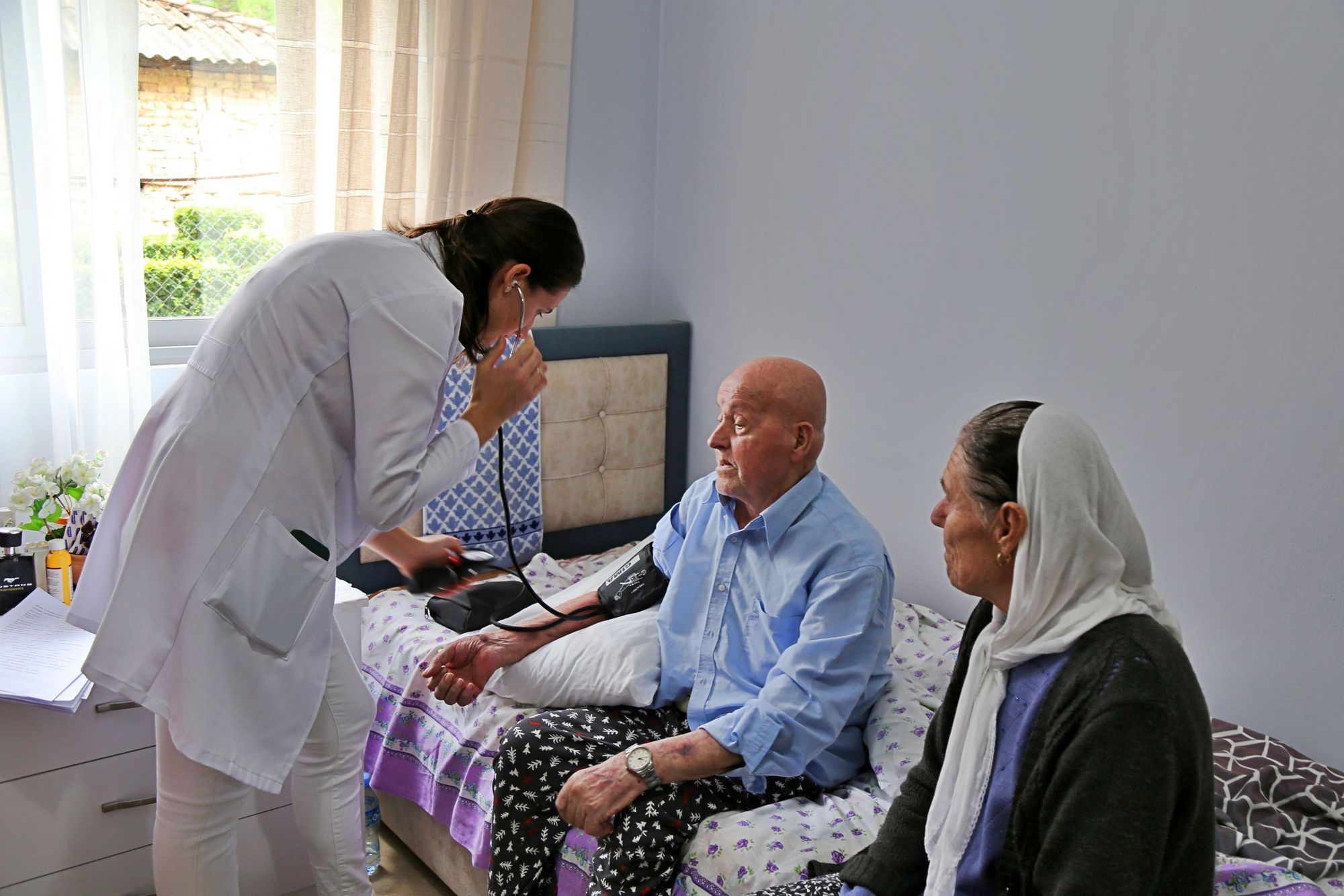 Home care nurse during a home visit. Two elderly people in Gostima Healthcentre, Elbasan