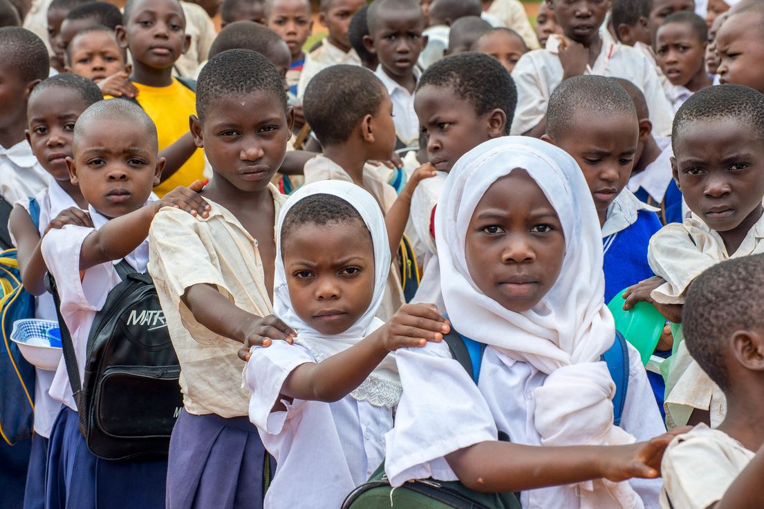 Students in the Lindi region of Tanzania in line to receive medicines for NTDs during a mass drug administration.